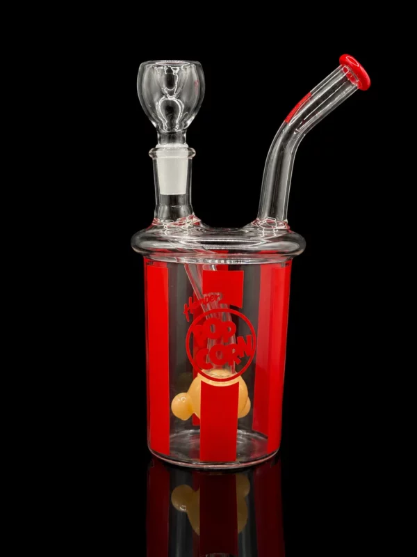 Bong Popcorn HEMPER en verre borosilicate en forme de seau de pop-corn de cinéma rayé rouge et blanc avec percolateur grain de maïs ambré